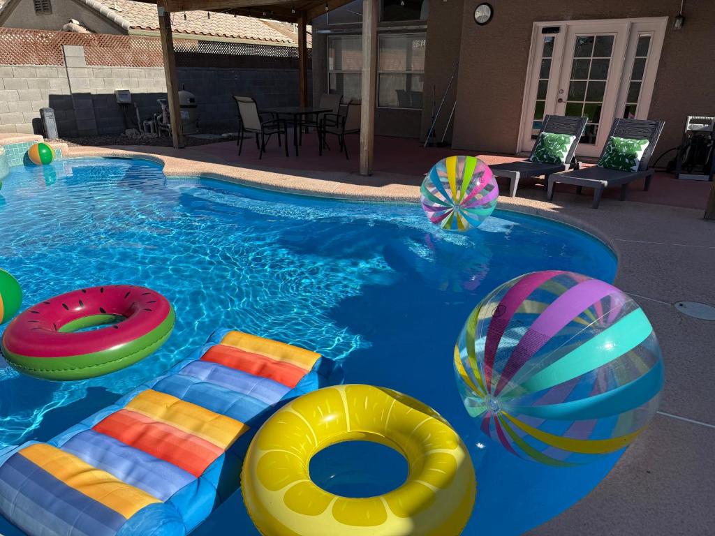 a swimming pool with colorful inflatables in it at Pool House Newly Remodeled 3bed 3bath Near DT Summerlin and Red Rock in Las Vegas