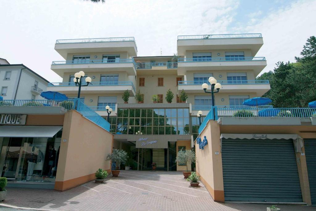 a large building with a parking lot in front of it at Albergo Le Sorgenti in Chianciano Terme