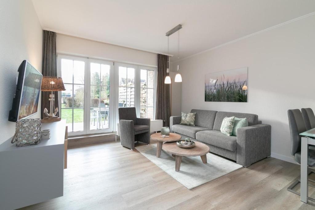 a living room with a couch and a table at Seepark Strandglück in Scharbeutz