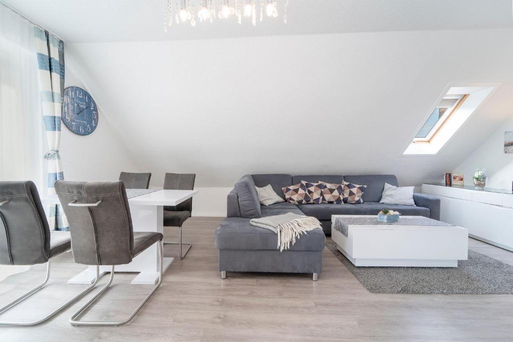 a living room with a couch and a table at Blankwasserweg 16- Sonnenseite in Grömitz