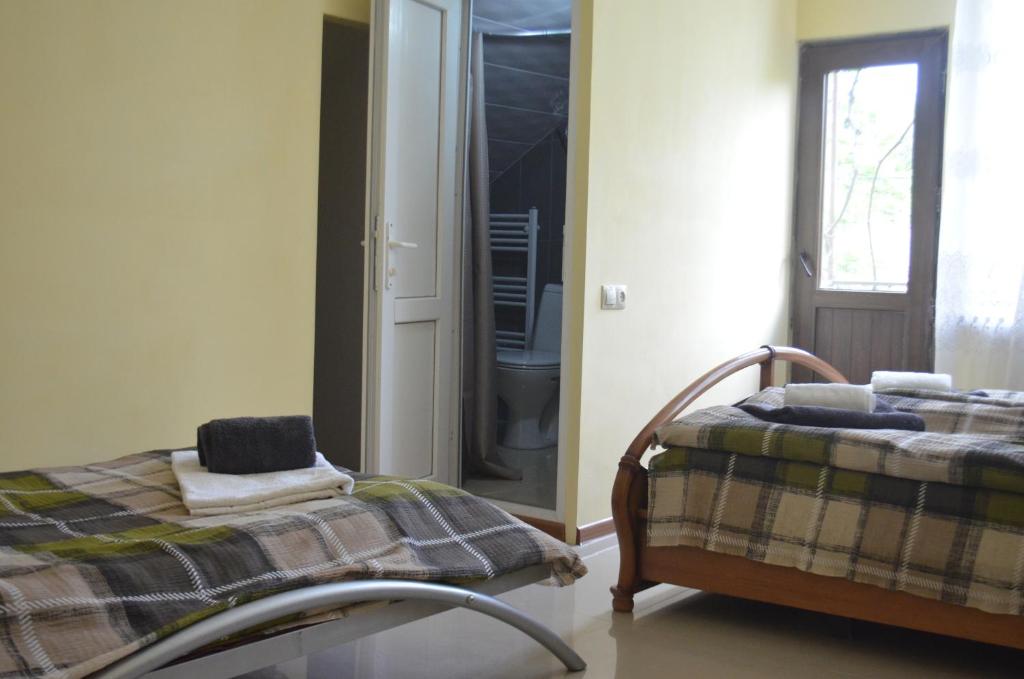 Postel nebo postele na pokoji v ubytování Alex's Cosy Guesthouse