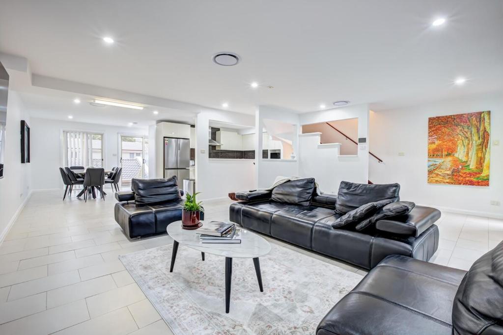 a living room with a couch and a table at Lakeview Family Retreat Canberra Cozy Townhouse in Gungahlin
