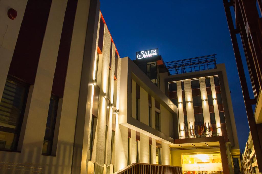 a building with a sign on the side of it at Salis Hotel & Medical Spa in Turda