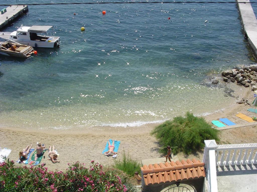 a view of a beach with people in the water at Apartments Anita 1 in Barbat na Rabu