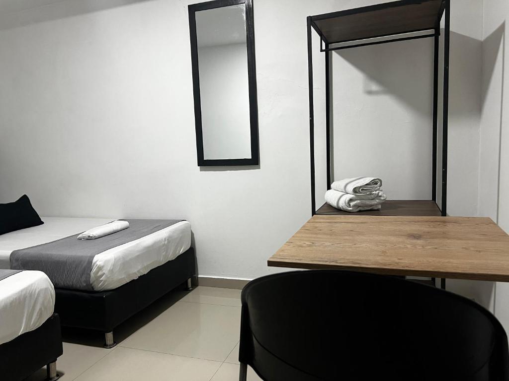 Postel nebo postele na pokoji v ubytování Hotel Laureles Aburrá