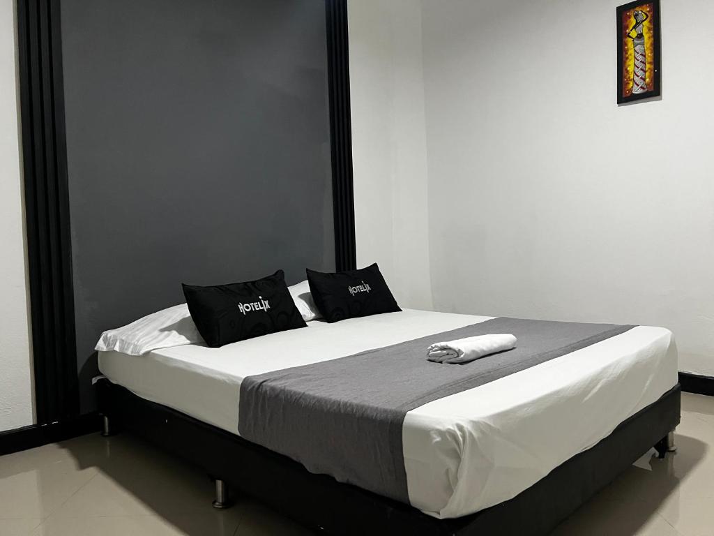 Postel nebo postele na pokoji v ubytování Hotel Laureles Aburrá