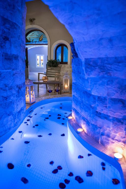 an indoor aquarium in a home with a blue lit room at Suite Home Santorini in Fira