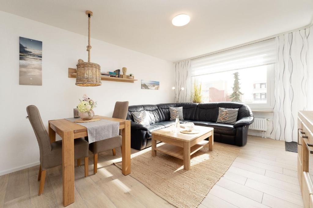 a living room with a couch and a table at Haus Wiking- Nordstern in Grömitz