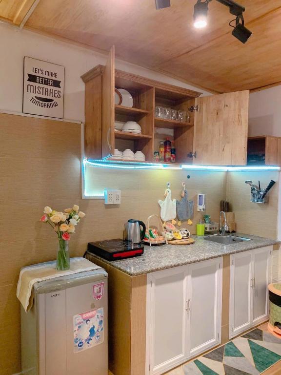 a kitchen with a sink and a counter top at Chút Homestay in Xuan An