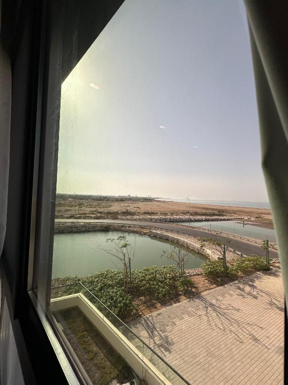 a window with a view of a body of water at Sea & Lagoon View in The Wave in Muscat