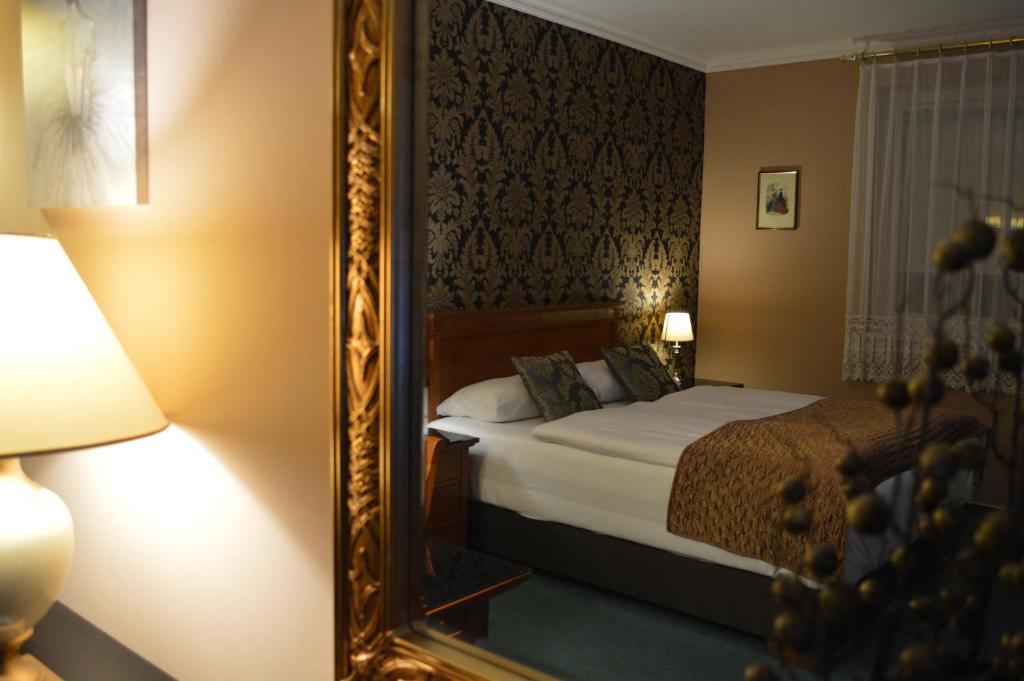 Postel nebo postele na pokoji v ubytování Platán Hotel