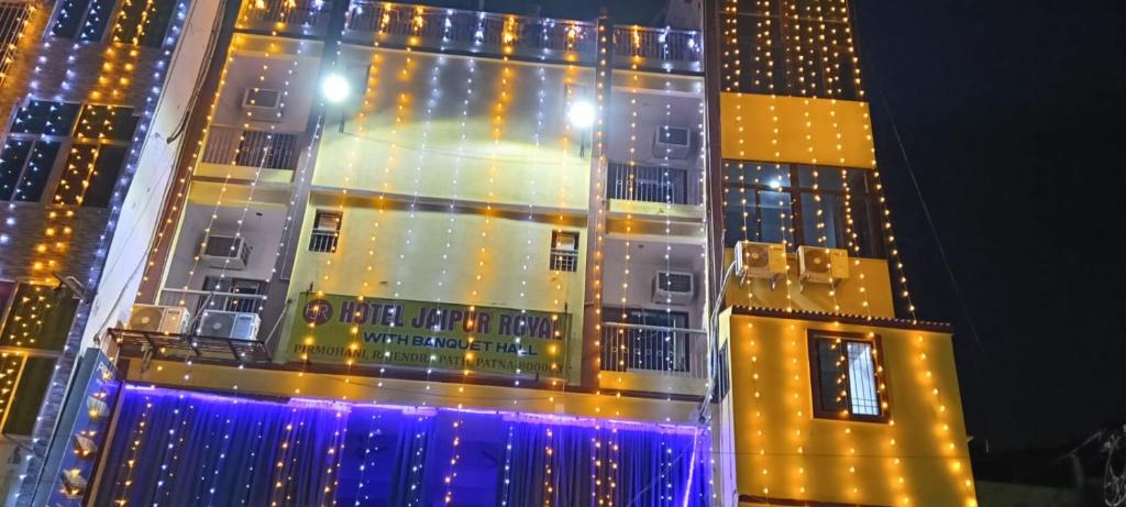 a tall building with lights on it at night at Hotel Jaipur Royal in Patna
