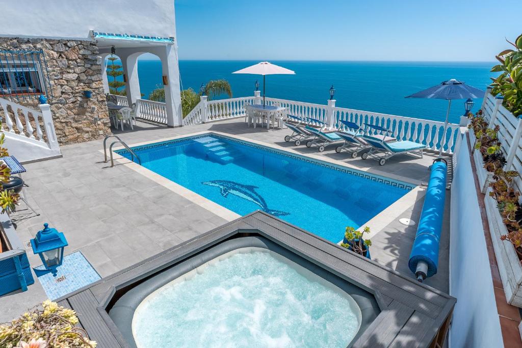 a swimming pool with a slide in the middle at Villa Buganvilla en Salobreña in Salobreña