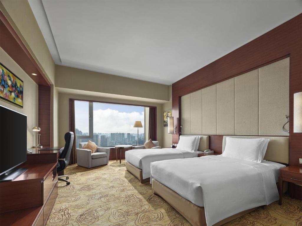 Postel nebo postele na pokoji v ubytování Hilton Hefei