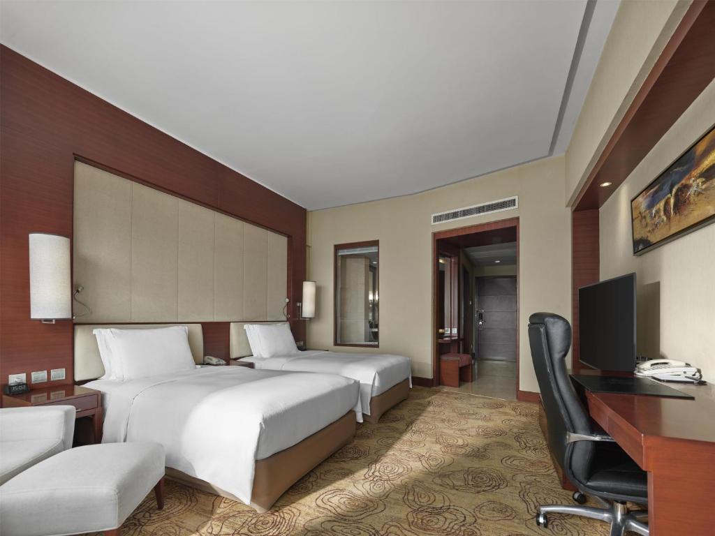Postel nebo postele na pokoji v ubytování Hilton Hefei