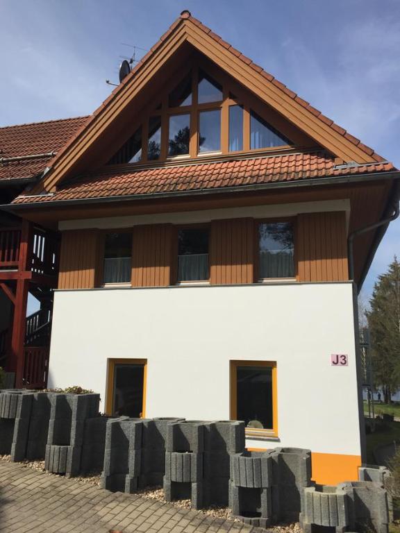a house with a brown roof on top of it at Apartmán Martin in Lipno nad Vltavou