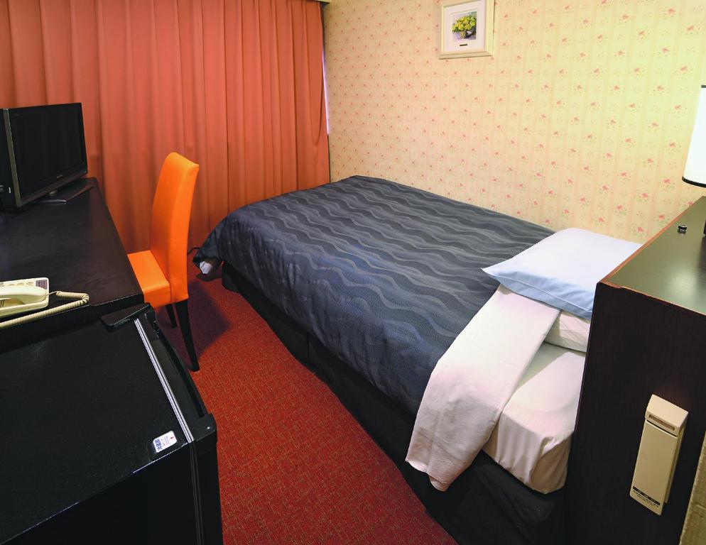 Postel nebo postele na pokoji v ubytování Bandai Silver Hotel