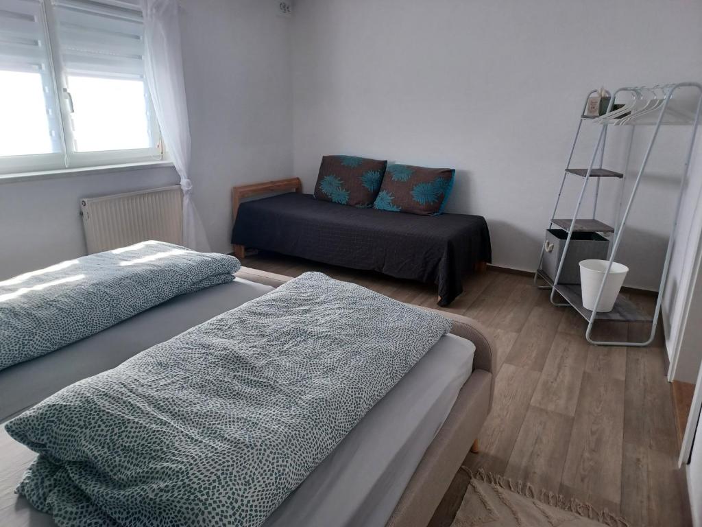 a room with two beds and a chair in it at Ferienhaus Anna Altstadt von Sonneberg in Sonneberg