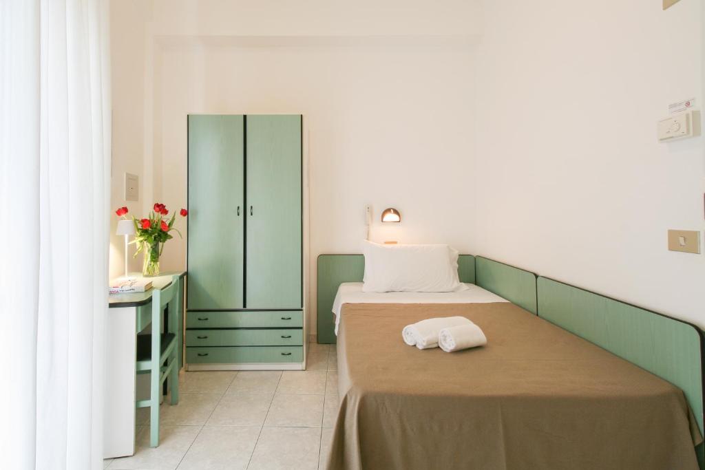 Postel nebo postele na pokoji v ubytování Ambra Hotel Cattolica