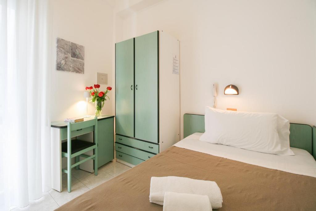 Postel nebo postele na pokoji v ubytování Ambra Hotel Cattolica