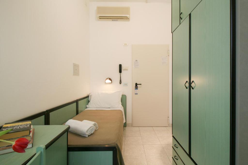 Postel nebo postele na pokoji v ubytování Ambra Hotel Cattolica