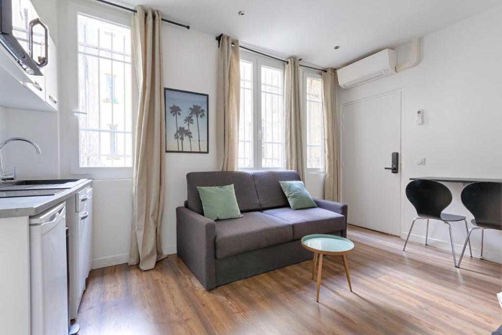 un salon avec un canapé et une table dans l'établissement TBS 306 - Lovely studio in Paris, à Paris
