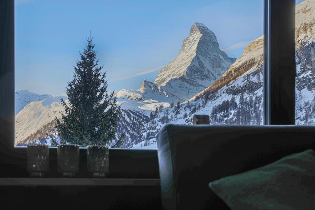 a window with a view of a snow covered mountain at Creatini Mountain in Zermatt