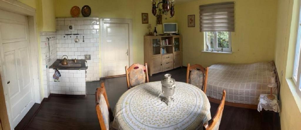 a kitchen with a table with a cat sitting on it at Agroturystyka Przy Wąwozie in Karmanowice