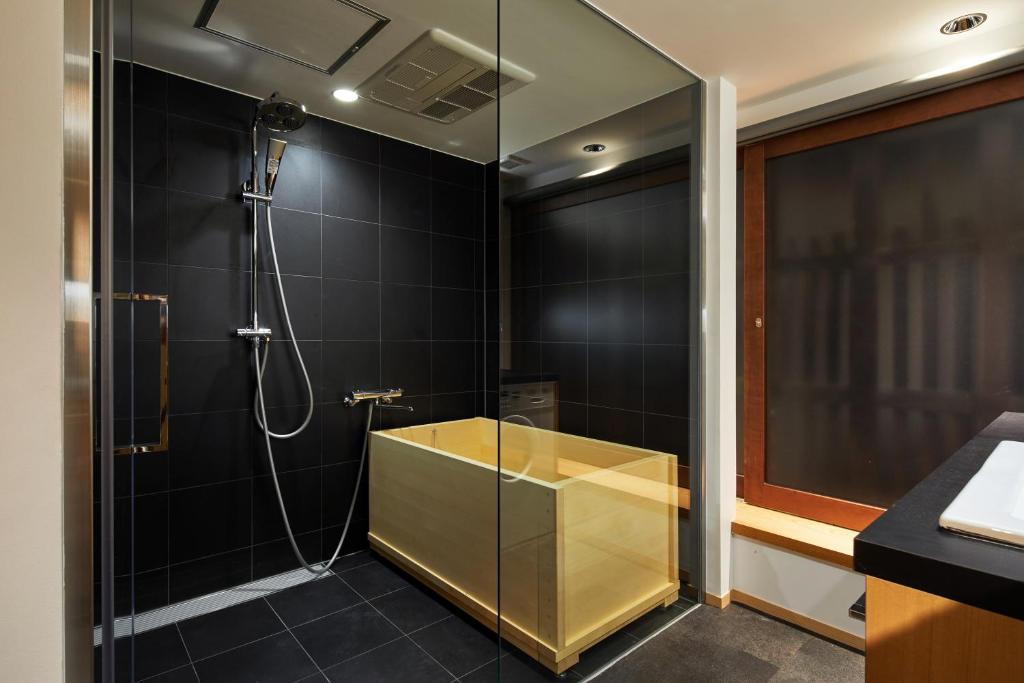 a bathroom with a shower with a glass wall at Enso Machiya in Kyoto