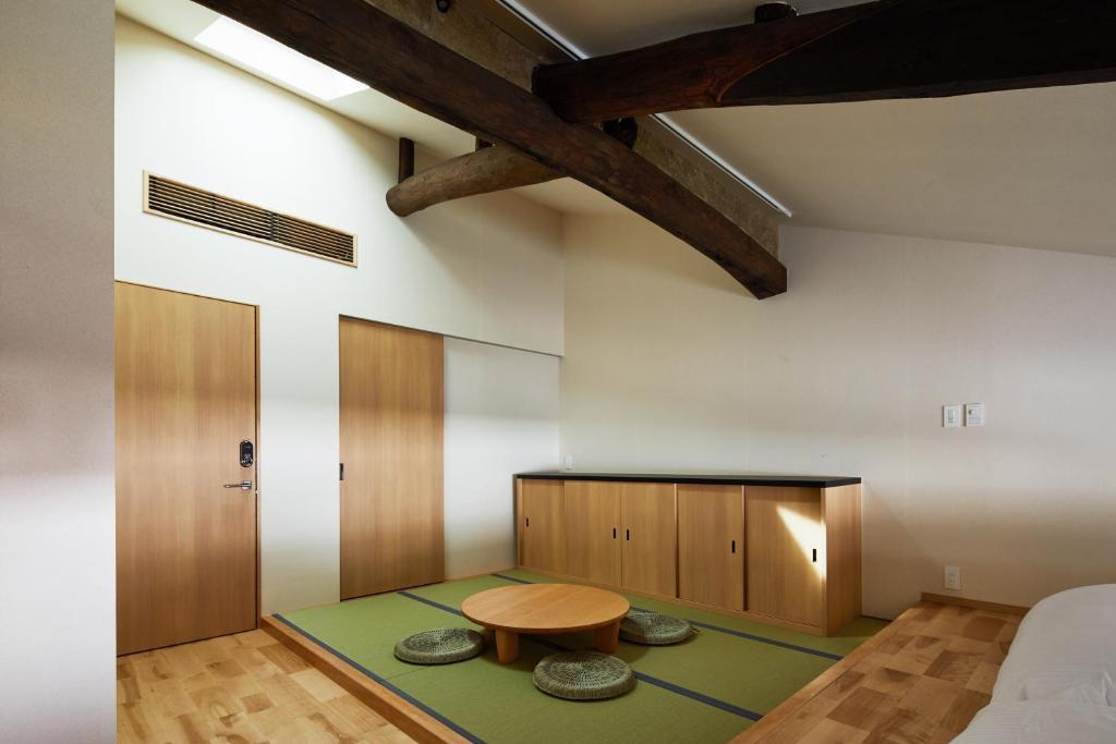 a room with a bed and a table in it at Enso Machiya in Kyoto