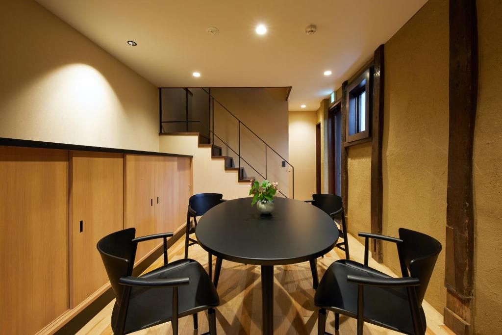 a dining room with a table and chairs at Enso Machiya in Kyoto