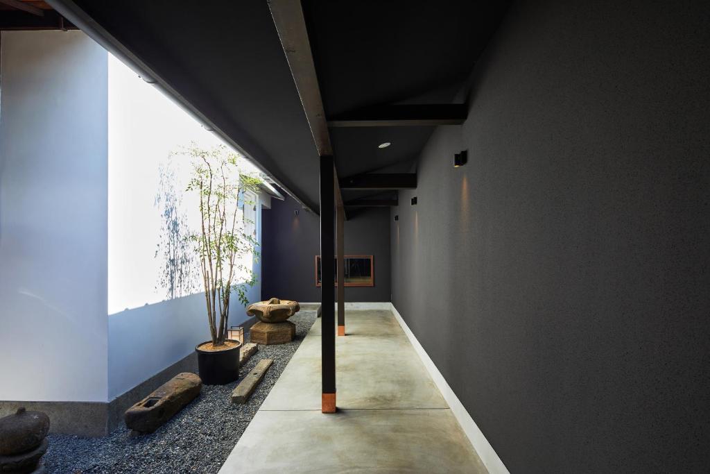 a hallway with a large window in a building at Enso Machiya in Kyoto