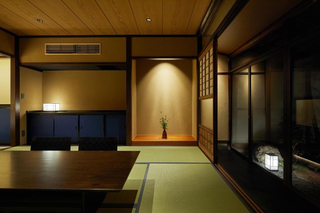 a large room with a table and chairs in it at Enso Machiya in Kyoto