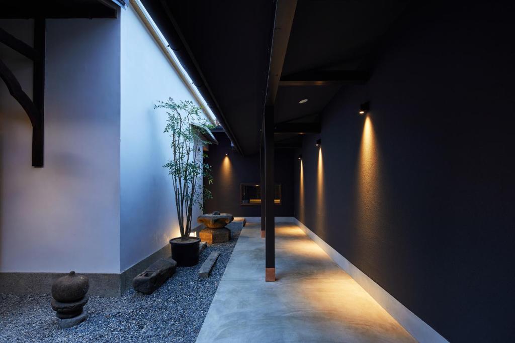 a hallway of a building with lights on the wall at Enso Machiya in Kyoto