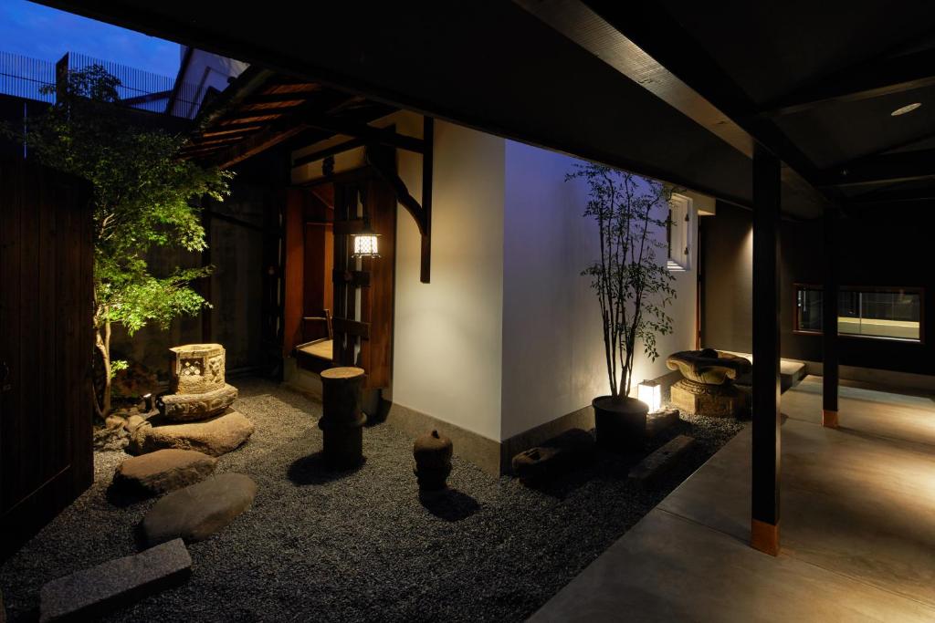 a room with rocks and a room with a building at Enso Machiya in Kyoto