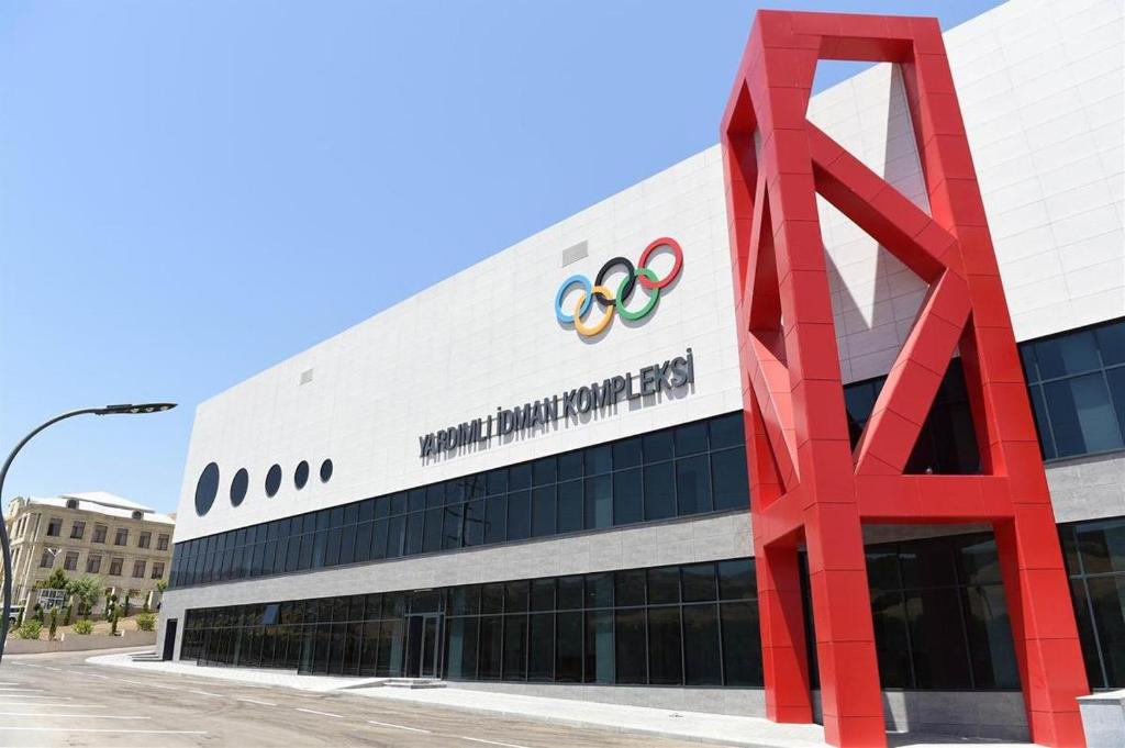 a building with a red sculpture in front of it at Arena Hotel Yardimli in Kabakhdibi