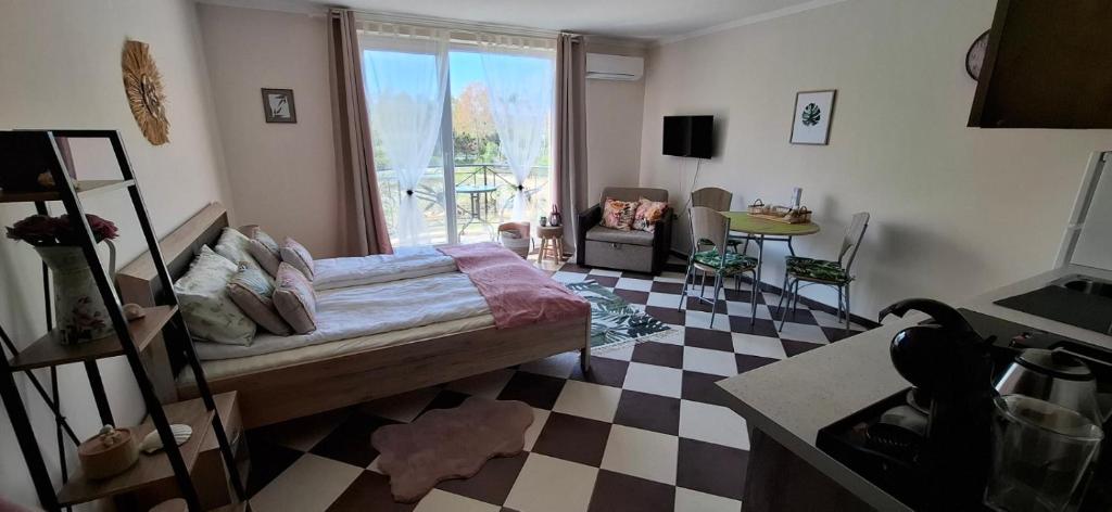 a bedroom with a bed and a checkered floor at Cozy Studio in Hacienda by Flat Mаnager in Sozopol