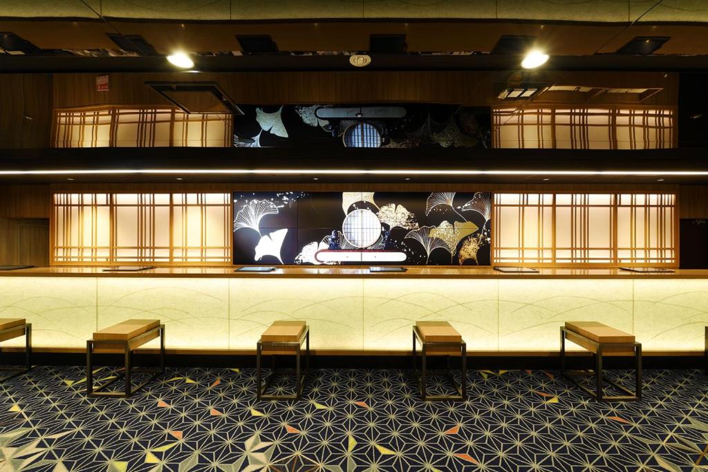 a lobby with chairs and a counter with a display at Shinjuku Prince Hotel in Tokyo