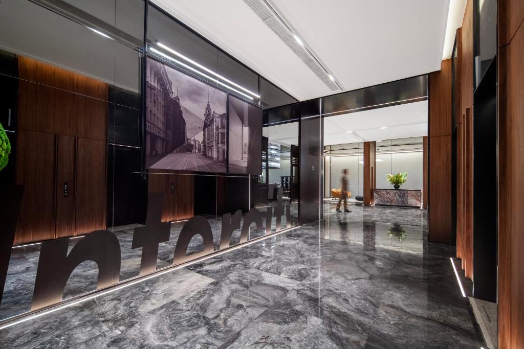 a lobby with a sign on the wall of a building at Intercity Hotel Shanghai City Center - Free Mini Bar in Shanghai