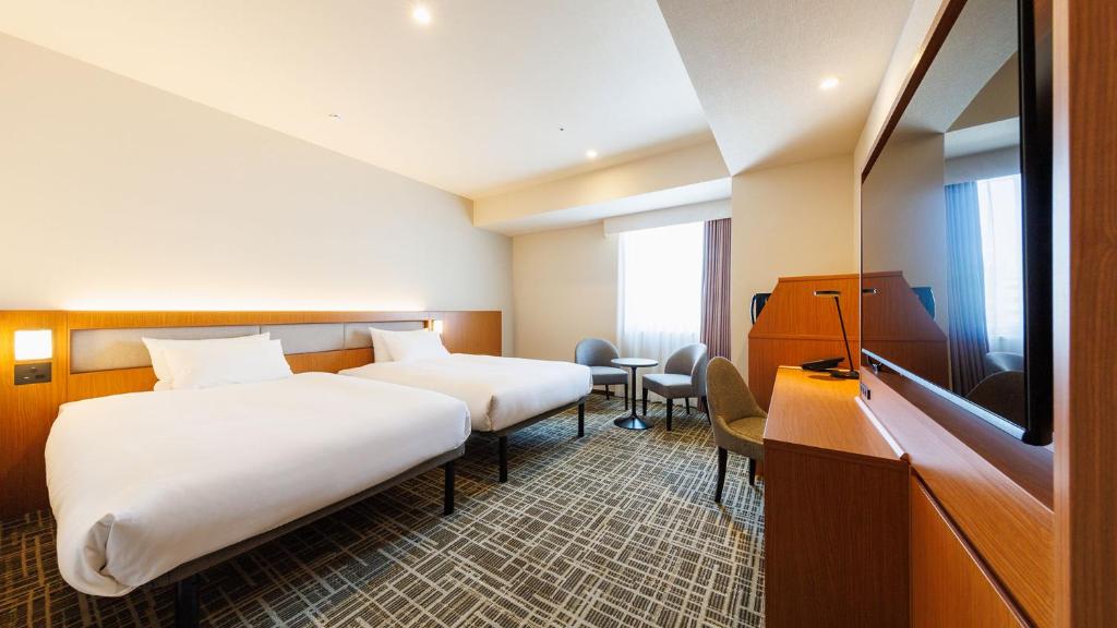 Postel nebo postele na pokoji v ubytování JR-East Hotel Mets Komagome