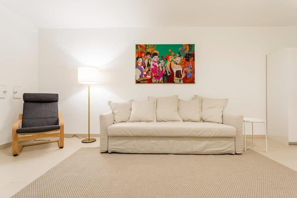a living room with a couch and a chair at Berlin Mitte I 2 doule beds I fast wifi in Berlin