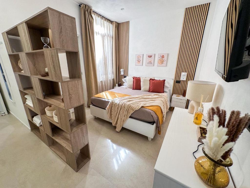 a bedroom with a bed and a book shelf at Ti porto al mare - Luxury & Relax in Siracusa