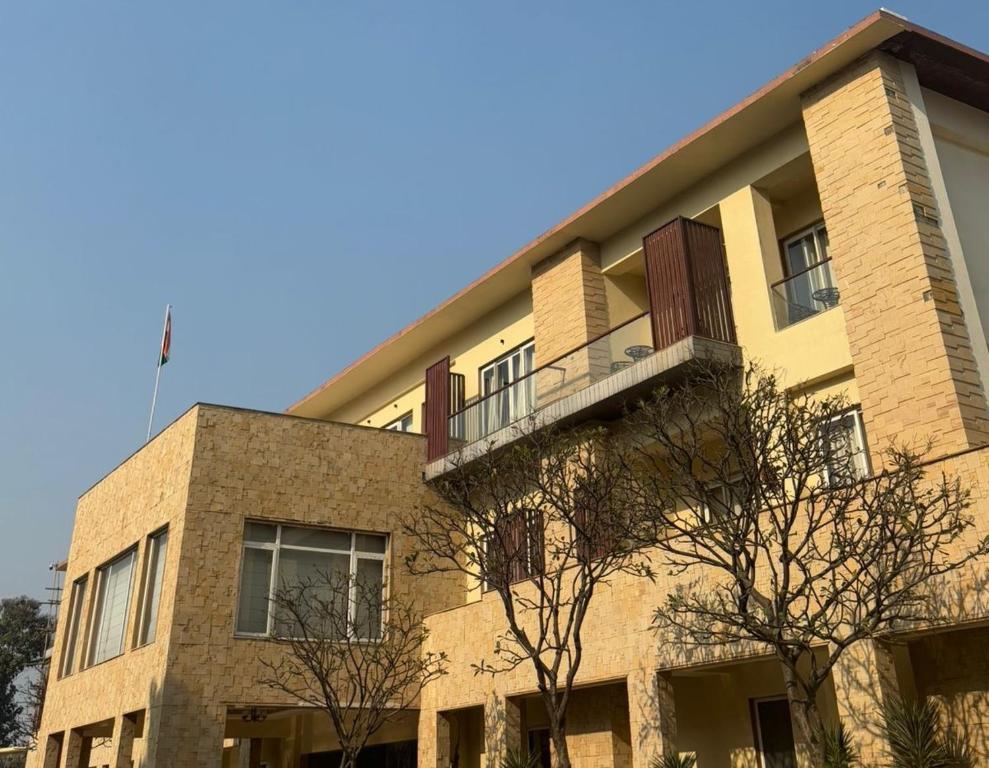 a building with a balcony on top of it at Ritz Resort Lucknow- The Perfect Blend of Business and Leisure in Lucknow