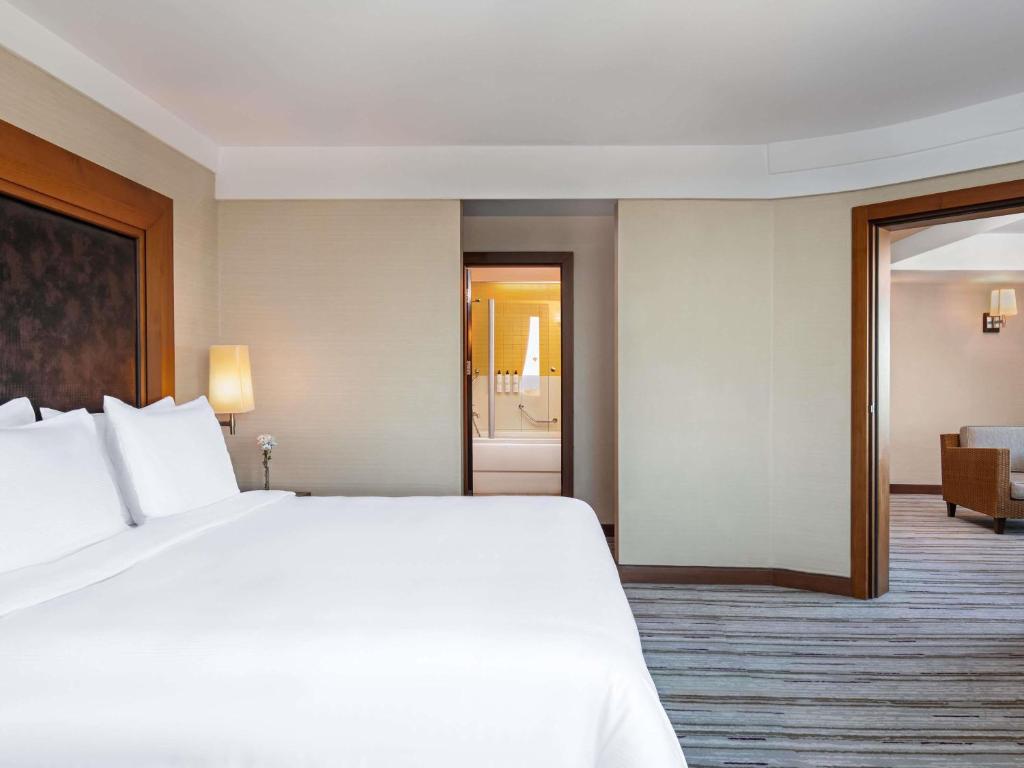 a large white bed in a hotel room at Rixos Sungate - The Land of Legends Access in Beldibi