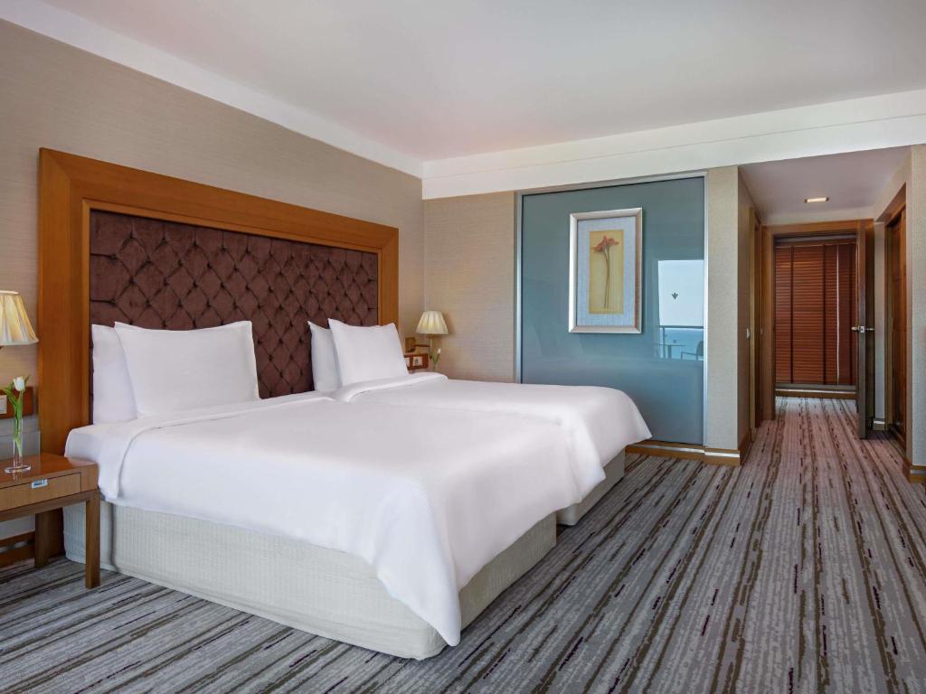 a large white bed in a hotel room at Rixos Sungate - The Land of Legends Access in Beldibi