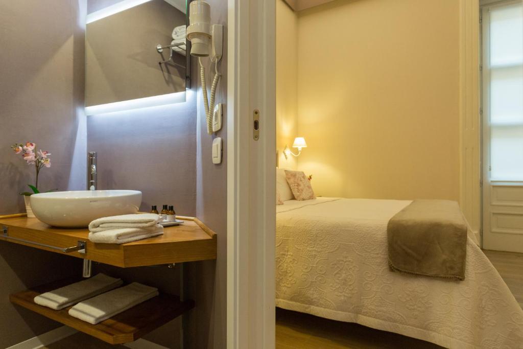 Una cama o camas en una habitación de Bellaroto Suite & SPA