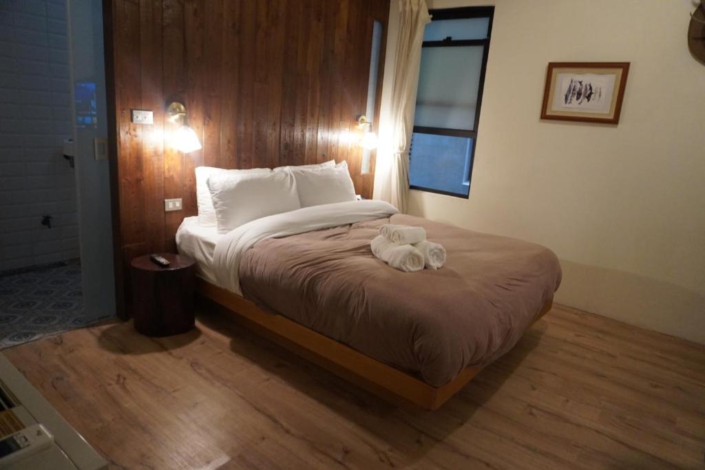 Postel nebo postele na pokoji v ubytování 泰森會館