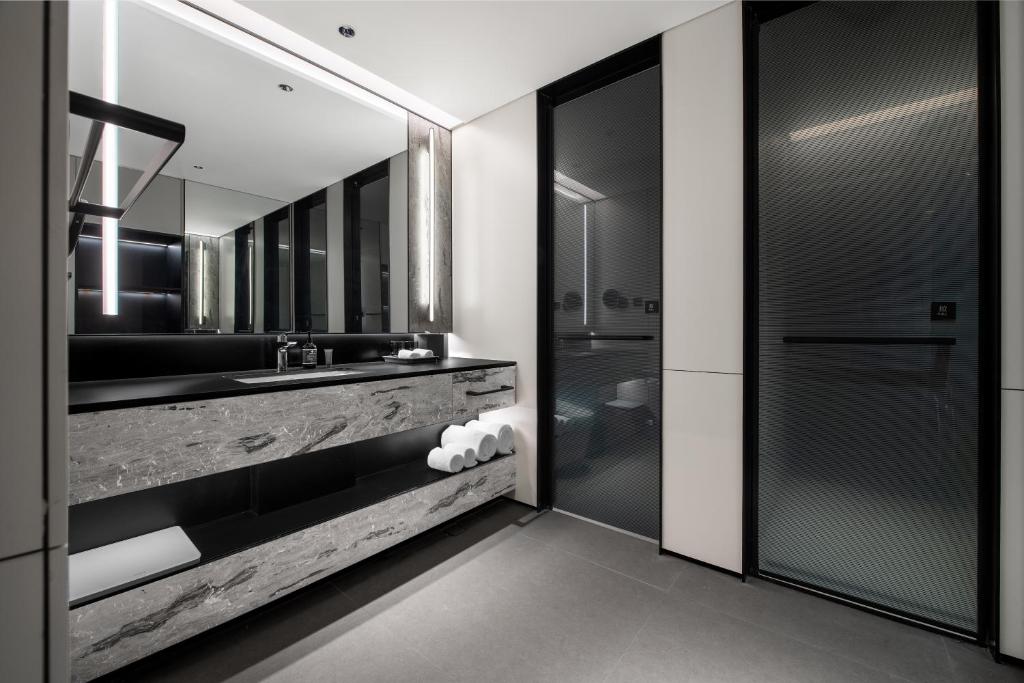 a bathroom with a sink and a mirror at Intercity Hotel Shanghai City Center - Free Mini Bar in Shanghai