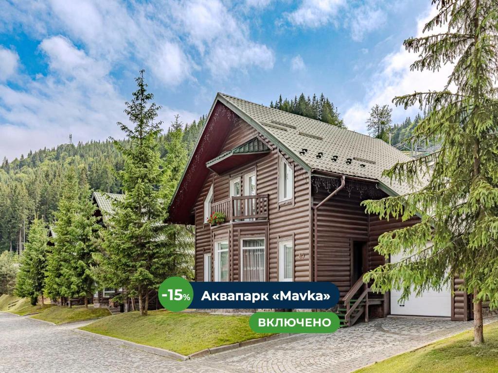a log house in the woods with a garage at Bukovel Hotel in Bukovel