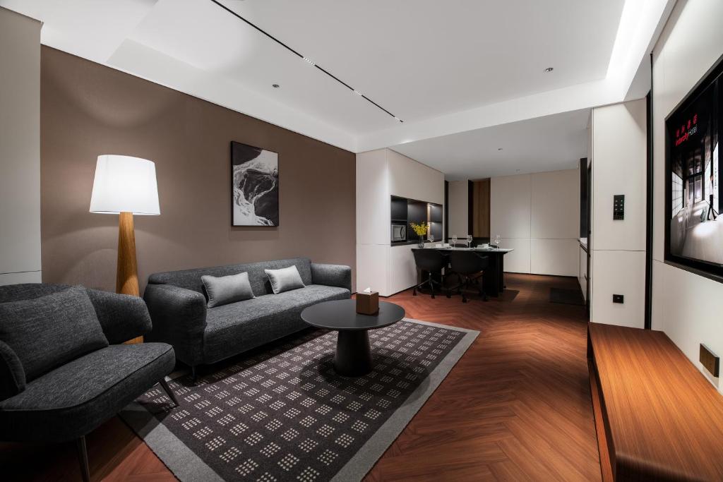 a living room with a couch and a table at Intercity Hotel Shanghai City Center - Free Mini Bar in Shanghai